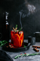 Hot mulled wine in a transparent glass on the table