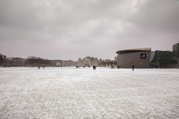 winter view of the white Museumplein or Museum square under the snow in Amsterdam, The Netherlands