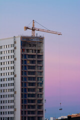 Fototapeta na wymiar A building under construction and a crane