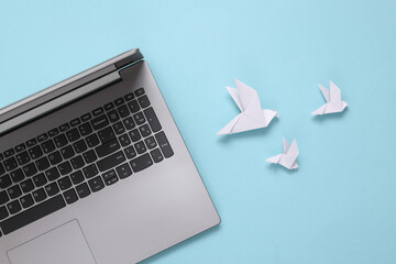 Notebook and origami pigeons on a blue background. Email