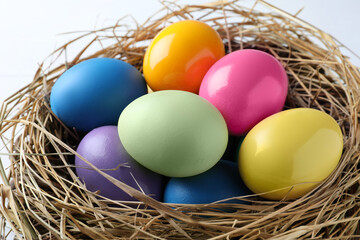 Fototapeta na wymiar Bright painted eggs in nest, closeup. Happy Easter