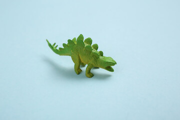 Toy stegosaurus dinosaur on blue background © splitov27
