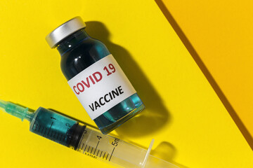 Transparent glass vials with test COVID-19 vaccine, with syringes