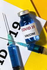 Transparent glass vials with test COVID-19 vaccine, with syringes