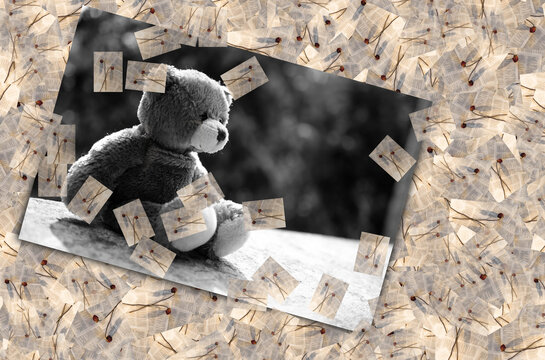 Broken heart concept. black and white image of teddy bear sad face sitting on cement wall with frame dry rose background. for isolation, loneliness, abandoned child, conceptual.