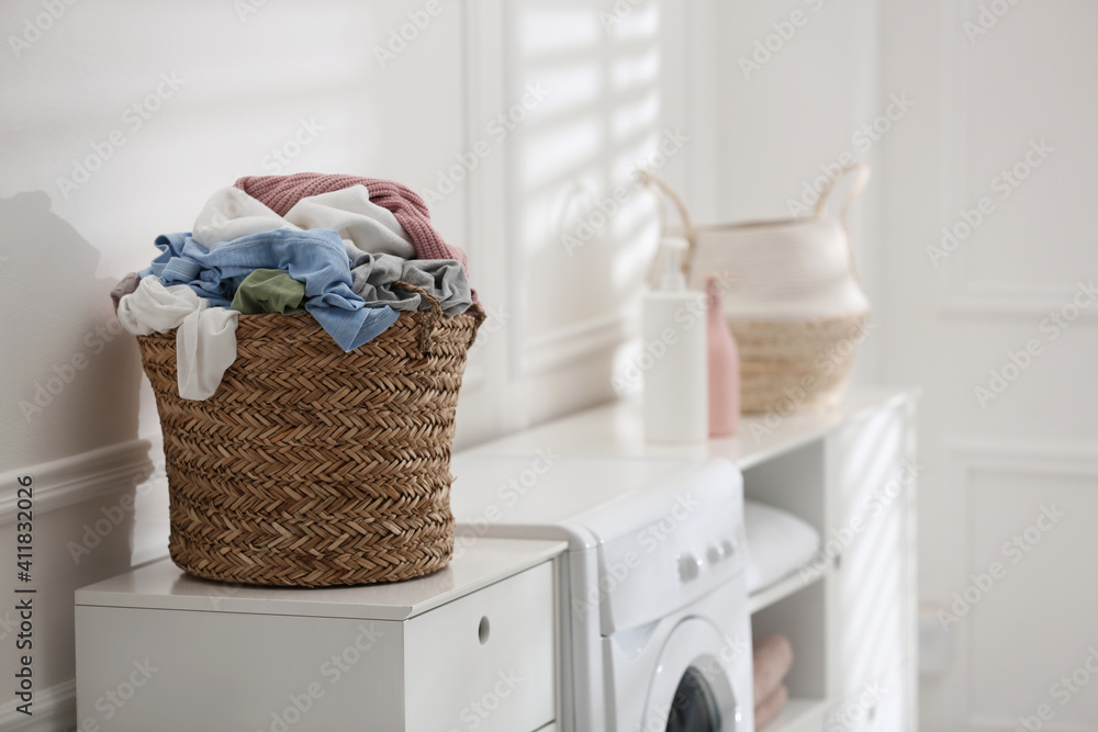 Canvas Prints Wicker basket with dirty laundry on washing machine indoors, space for text