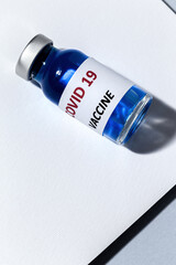 Transparent glass vials with test COVID-19 vaccine, with syringes