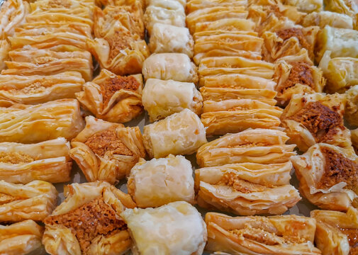 Arabic cuisine; Traditional Arabic dessert "Basbousa" .Egyptian oriental semolina cake topped with golden crispy almond. Served with tea, honey syrup and fresh tasty cream.