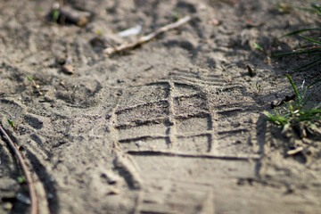 A footprint in the sand from a shoe or boot