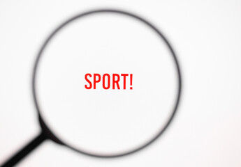 Text sport on white screen through magnifying glass. Healthy lifestyle
