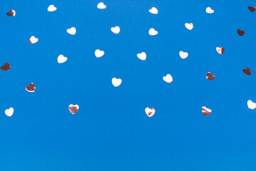 Glitter heart on blue color background. Valentine day. Copyspace for text. Top view, flat lay. Holiday backdrop.