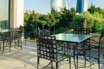 Close up view of outdoor tables of restaurant waiting for customers.