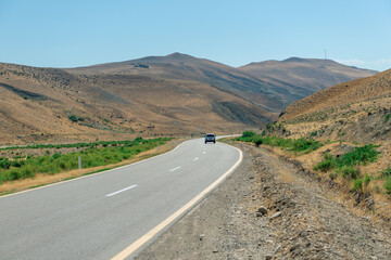 alone car on the road in the desert mountains of Azerbaijan landscape