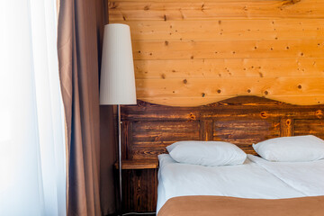 morning scene in bedroom with metal desk lamp and  pillow on bed