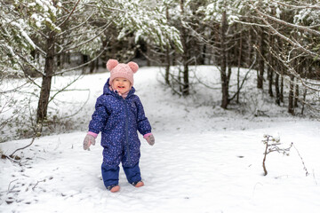 Fototapeta na wymiar Happy baby girl in snowy country
