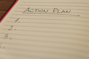 Lined notebook page with the words 'Action plan' in black ink on white paper.