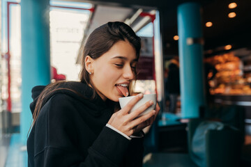 Close up portrait of pretty female drinking coffee.