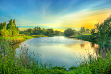Fototapeta na wymiar Amazing colorful sunrise on the lake in Poland