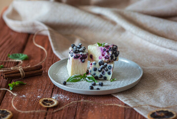 No-baking cheesecake with blueberry and mint on brown wood background and cloth