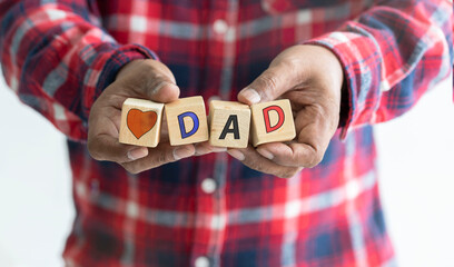A man holding a wooden box writing heart and dad on Father's Day 