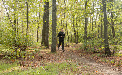 Sport Man runningon in forest. Healthy active man jogging