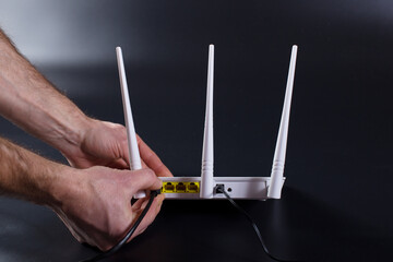 Hands connecting wifi router. Internet network setup. - obrazy, fototapety, plakaty