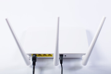 Router with three atennas. White wifi router on a white background.