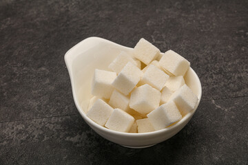 Refined white sugar cubs in the bowl