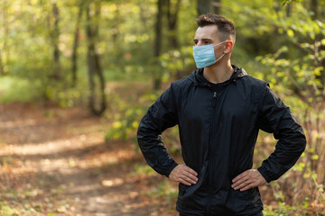 Portrait of active man in medicine face mask in forest
