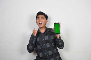 Asian man holding mobile phone with green screen