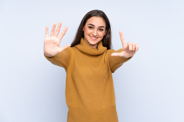 Young caucasian woman isolated on blue background counting seven with fingers