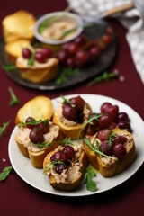 Selective focus. Toast with goose liver pate and baked grapes. A gourmet snack. Keto.