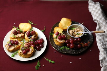 Selective focus. Toast with goose liver pate and baked grapes. A gourmet snack. Keto.