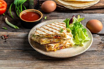 Traditional Mexican tortillas with quesadilla tortillas with scramble eggs, vegetables, ham and cheese. banner, menu, recipe