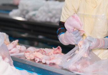 Packed chicken pieces in bags for sale to customers.