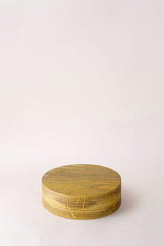 Background with wooden geometric shape and podium. Wooden round cylinder shape form for eco product. Empty showcase in minimal style. Abstract pastel mock up for cosmetic.