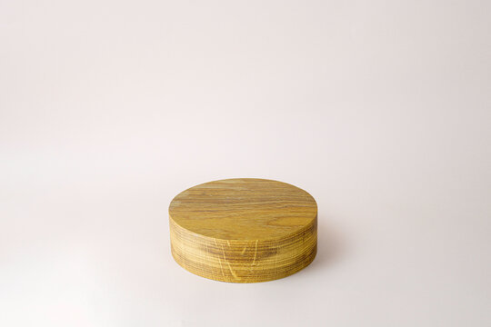 Background with wooden geometric shape and podium. Wooden round cylinder shape form for eco product. Empty showcase in minimal style. Abstract pastel mock up for cosmetic.