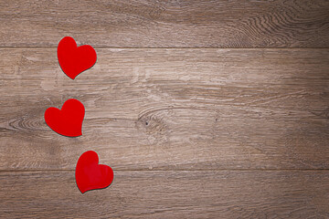 Red hearts on a wood background