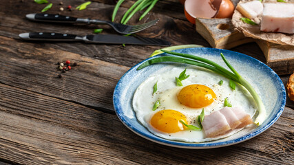 Bacon and egg as Ukrainian breakfast. fried egg and lard bacon. Food recipe background. Close up