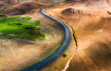 Aerial view on road in Iceland. Aerial landscape above highway in the geysers valley. Icelandic...