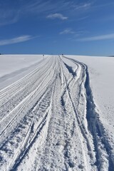 
A snowmobile trail under a blue sky, Québec