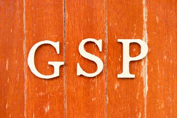 Alphabet letter in word GSP (Abbreviation of Good Storage Practice or Generalized System of Preferences or Gross State Product) on old red color wood plate background