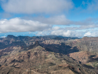 Fototapeta na wymiar Amazing view from Roque Nublo plateau on central volcanic mountains with Caldera and Barranco de Tejeda and Roque Bentayg rock. Gran Canaria, Canary Islands, Spain.