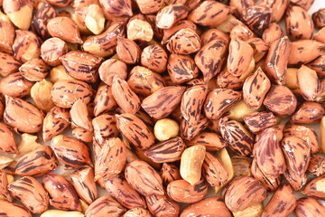 close up of baked salty tiger stripe peel peanut background and texture on white background