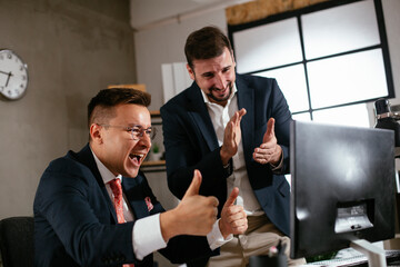 Businessman in office. Colleagues are celebrating a big accomplishment at work