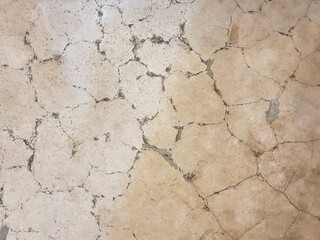 Old polished cement floor cracked.

