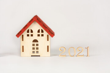 wooden house with an inscription from the signs of the numbers 2021. concept for lawyers, the adoption of new laws in suburban real estate 