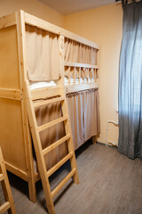Hostel has cozy bunk beds. Budget holiday destination for travelers, tourists and students. Copy space