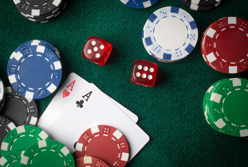 Stack of chips and two aces on the table on the green baize - poker game concept