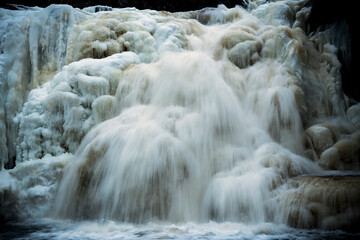 Frozen waterfall in Norwegian forest. Homla river in Norway.
